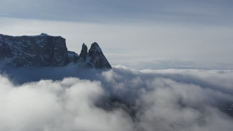 winte dolomites with drone over clouds