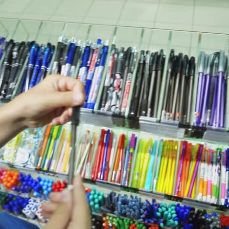vinnitsa, ukraine - august 20, 2018: boy in a stationery buys a pen. back to school concept.