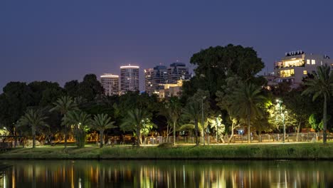 day to night, big full moon rising behind tel aviv city skyline