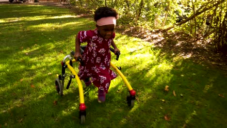 black girl with cerebral palsy walking in the park with her assistive device-1