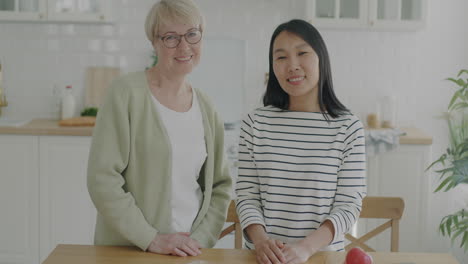 happy mother and daughter in the kitchen