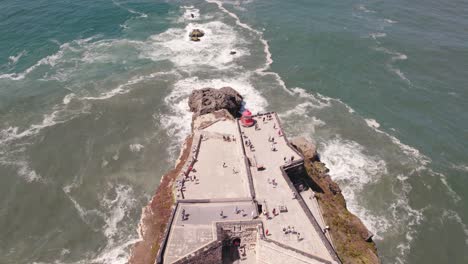 aerial view tourists on nazaré lighthouse descending reveal atlantic ocean horizon