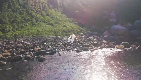 drone shot of pieces of boat standing on paradisiac island in a sunny day