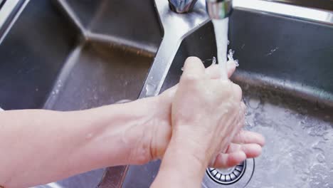 Old-lady-washing-her-hands-in-sink-4K-4k