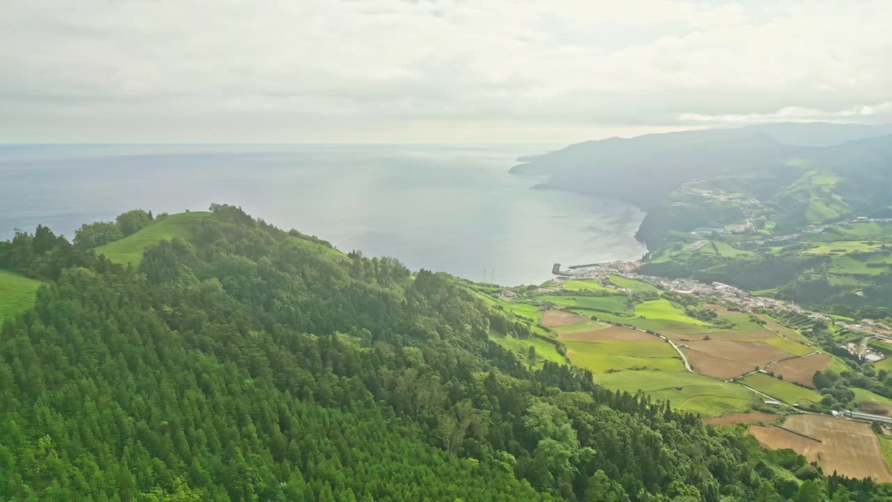Aerial view of Povoação, seaside village surrounded by lush vegetation and Atlantic Ocean, Azores