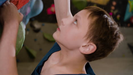 teenage boy bouldering indoors