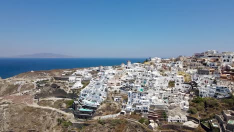 revealing drone shot of the city oia on the greek island of santorini