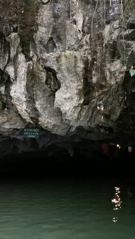 boat traverses through a serene water cave