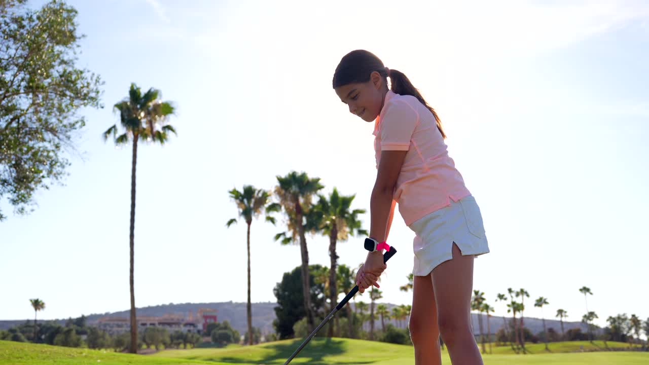 Girl playing golf on a sunny day