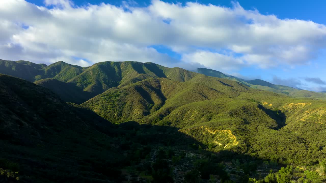 Aerial time lapse over the Palomar Mountains reveals nature in motion with clouds drifting across forested peaks in Southern California