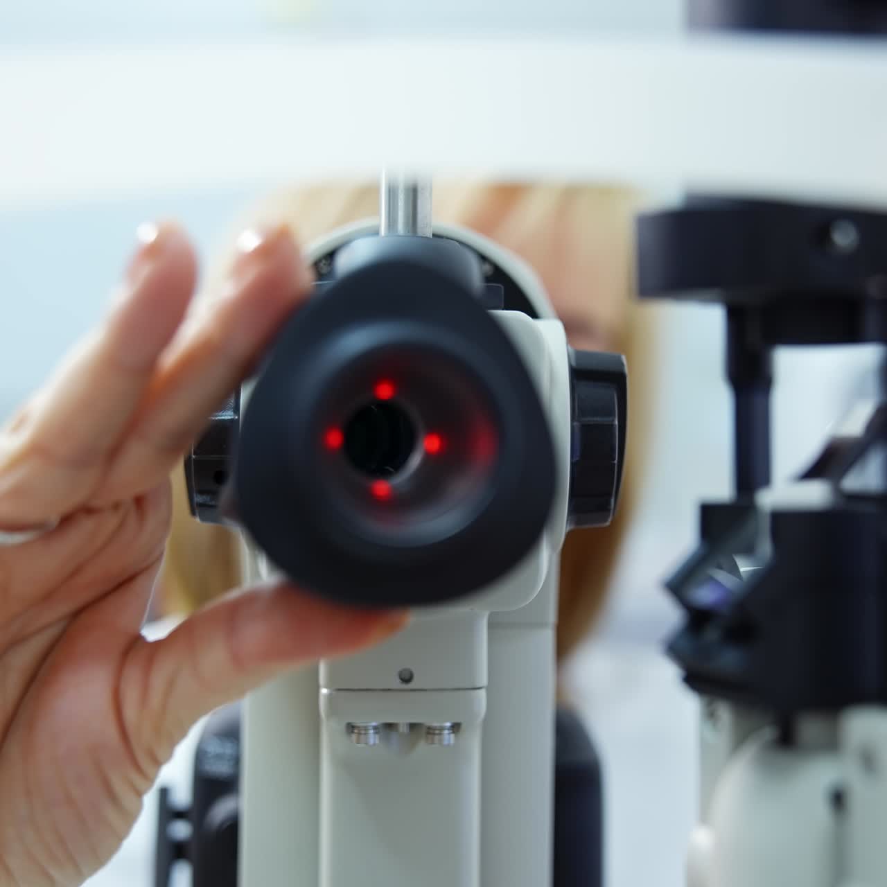 Apparatus for eyesight therapy. Doctor customizes device for checking patients eyes in ophthalmology center. Modern apparatus for eye testing. Close-up