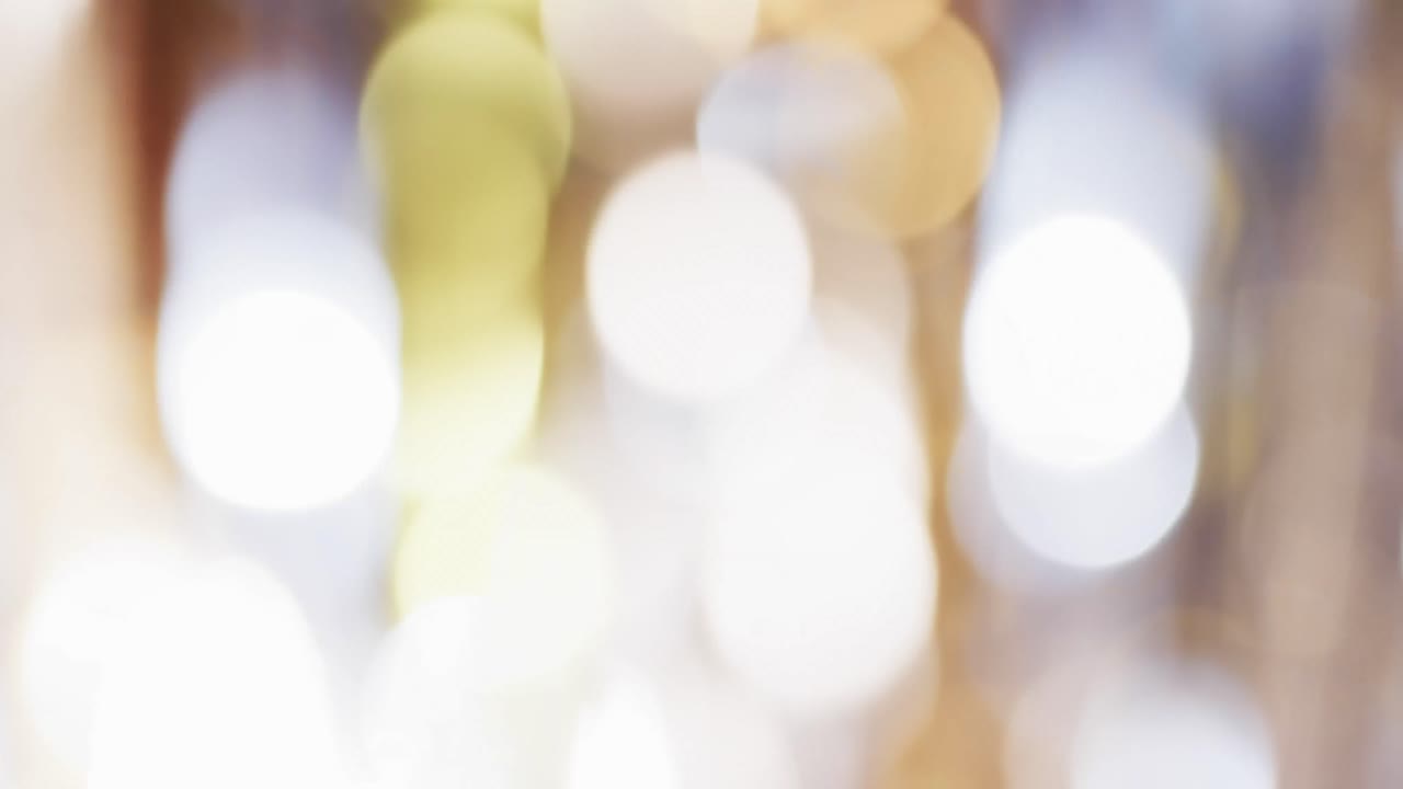 Video of flickering multi coloured bokeh spots of light with copy space