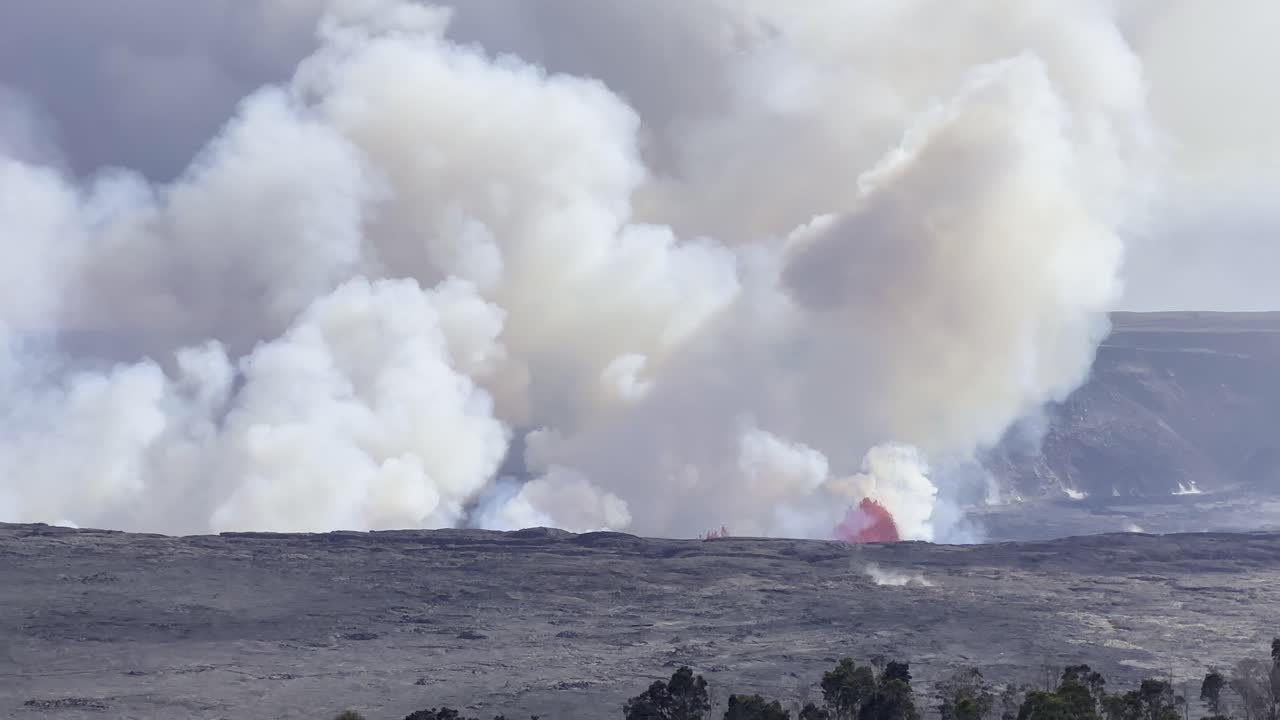 Cinematic long lens panning shot of Kilauea erupting as viewed from Volcano House on the first day of activity in September 2023 at Hawai'i Volcanoes National Park
