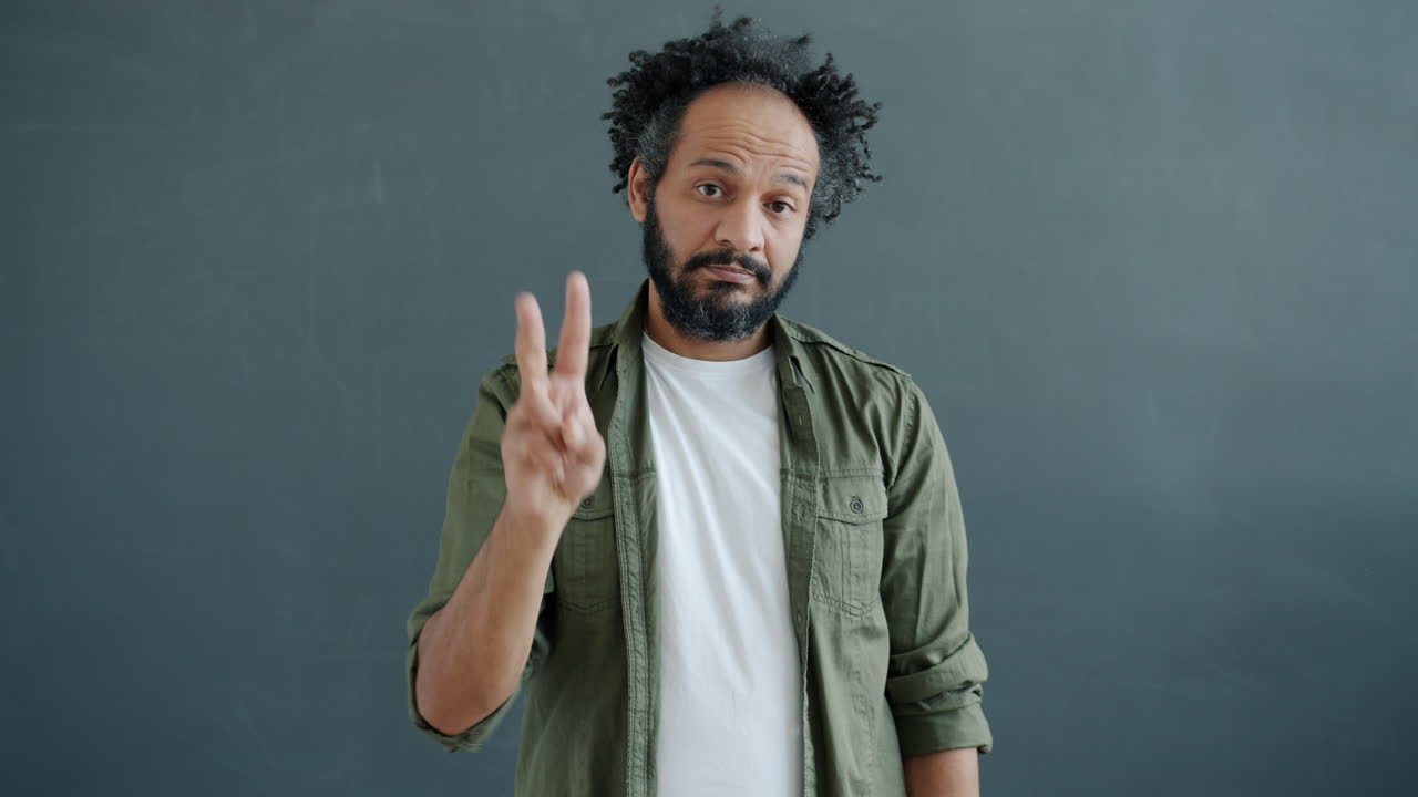 Man Making a Peace Sign Gesture