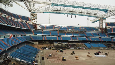 loader equipment working on the ground of a football stadium under construction