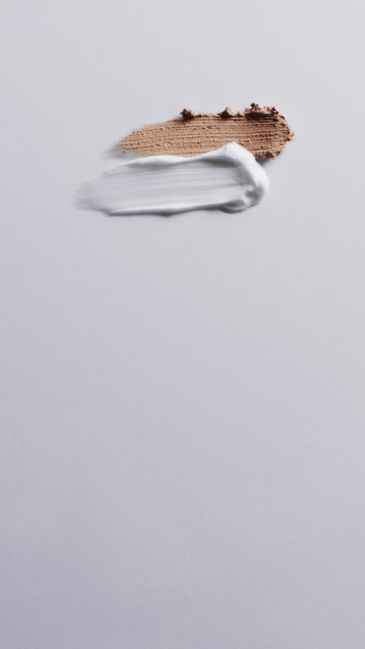 Vertical video of beauty product make up smudges with copy space on white background