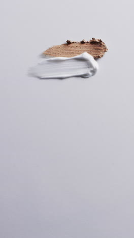 vertical video of beauty product make up smudges with copy space on white background