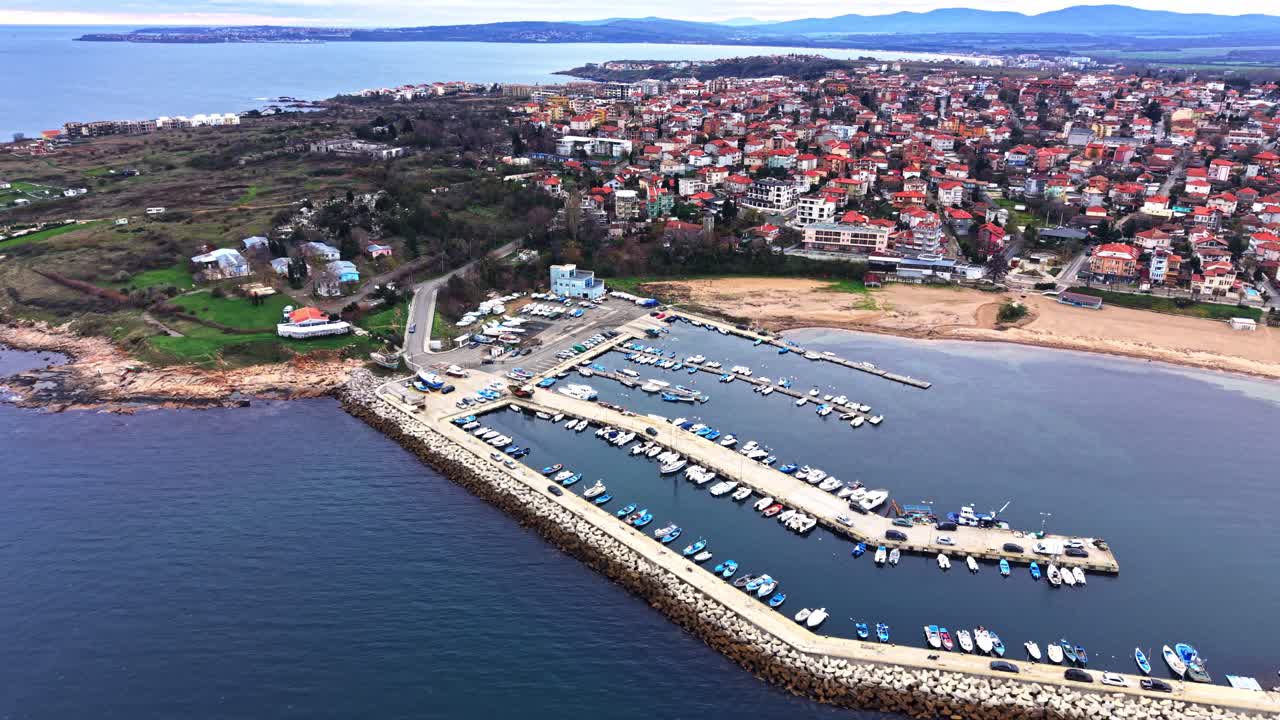 Coastal village with marina and residential area along the shore
