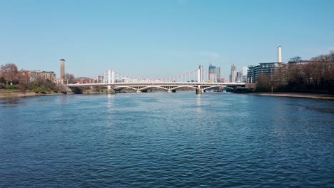 dolly forward rising reveal shot of london over chelsea bridge