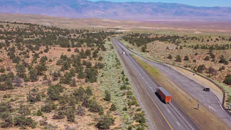 aerial over a truck traveling on highway 395 to reveal the owens valley and the eastern sierra nevada mountains of california