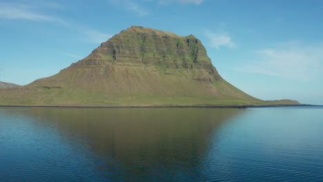 low level aerial pull out of kirkjufell mountain in iceland