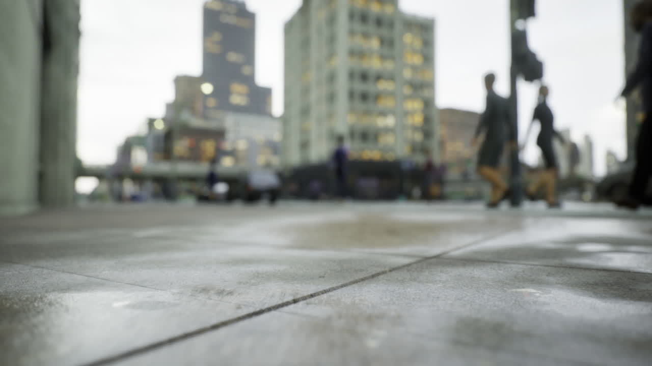 Urban rain transforms city streets into a reflective canvas at dusk