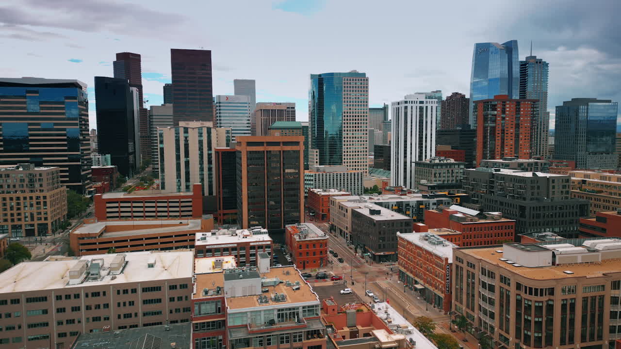 Denver, USA, 28 July 2025: Downtown of modern Denver, Colorado, USA with high-rise buildings. Drone flight over the midtown on gloomy day