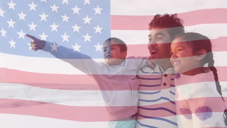 animation der flagge der vereinigten staaten von amerika über biracial vater mit sohn und tochter am meer