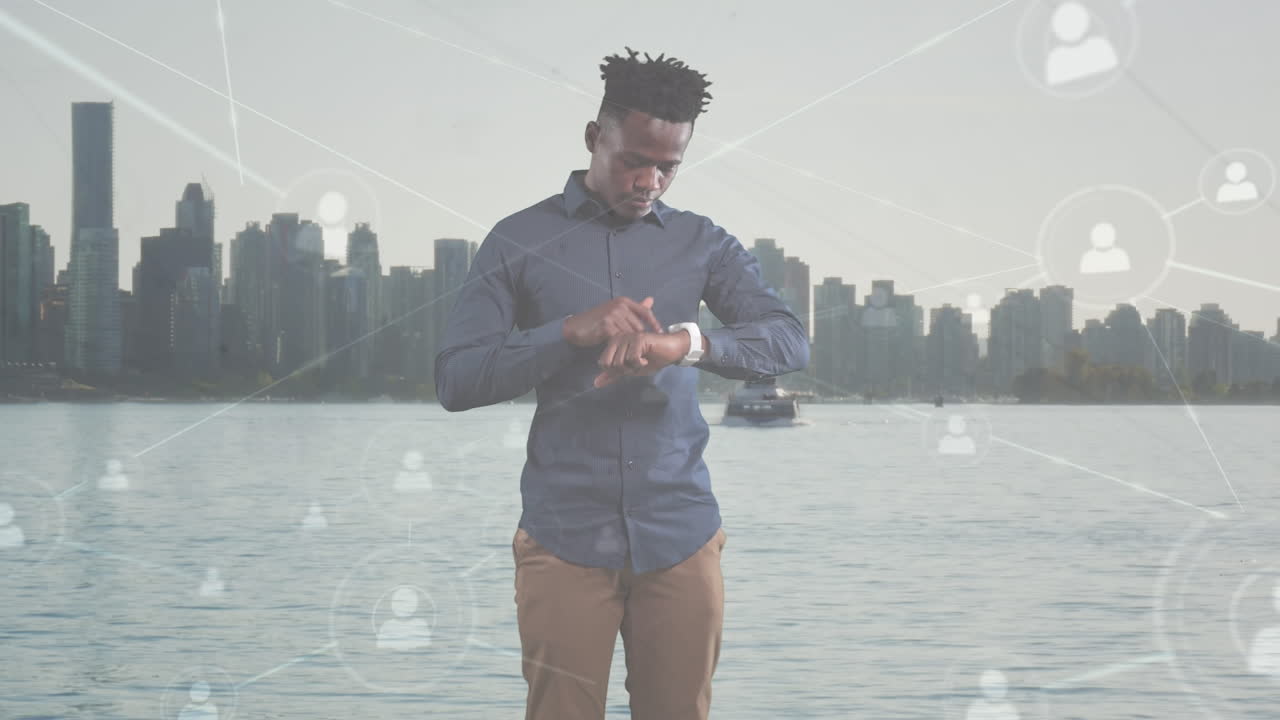 Animation of african american businessman using smartwatch over cityscape