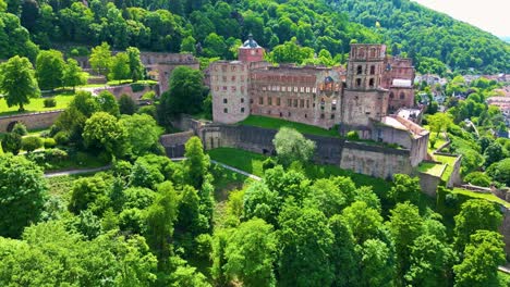 4k aerial drone video of ruins and gardens of the historic castle on königstuhl hill overlooking heidelberg, germany