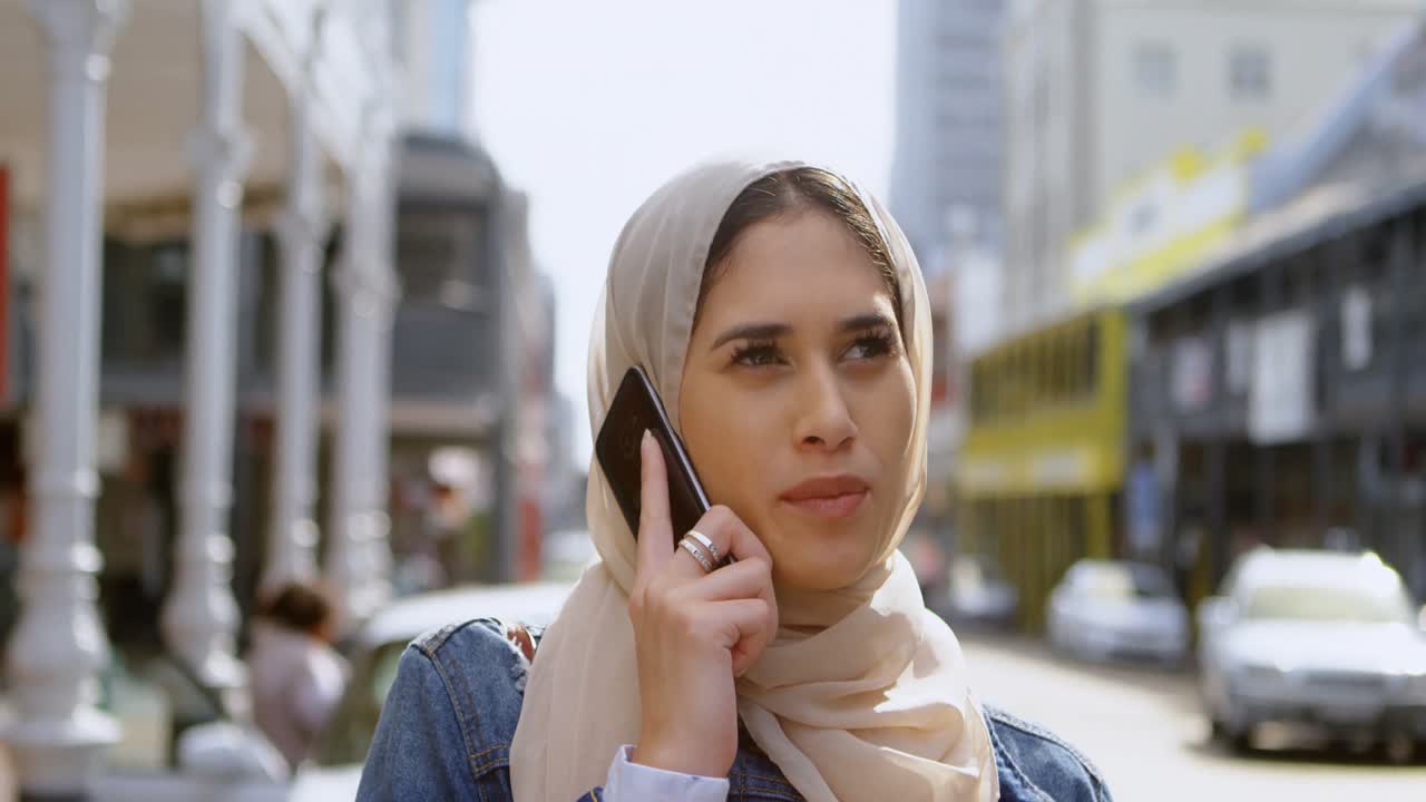 Woman in hijab talking on mobile phone 4k