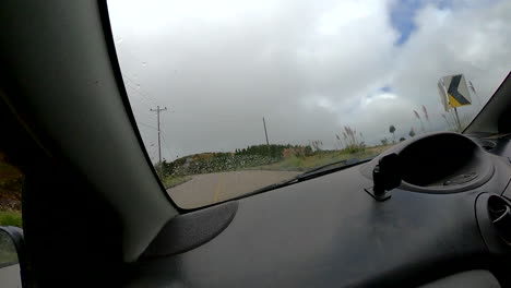 tracking-shot-of-car-driving-on-asphalt-road