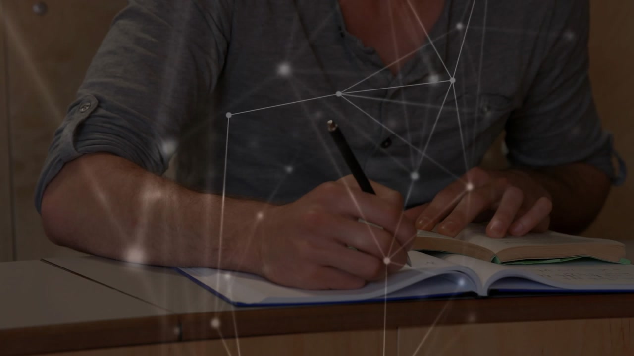 Student reading textbook taking notes with pen in notebook network drifting across pages education