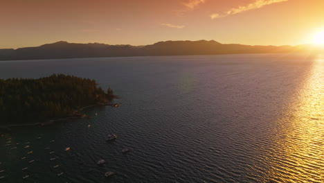 sunset over lake with island and boats