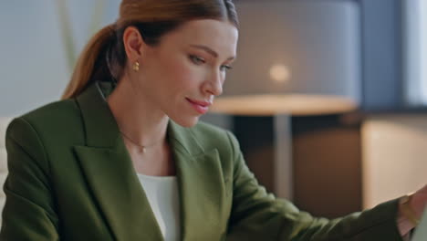 closeup lady opening computer at office. businesswoman started work at morning