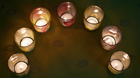 hindu festival of lights, dusshera and diwali preparation and celebration ingredients- decorative painted glasses with t-candles