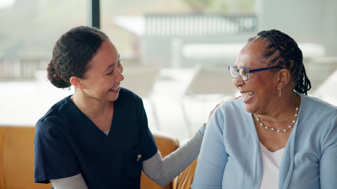 Caregiver Talking and Smiling with Senior Woman