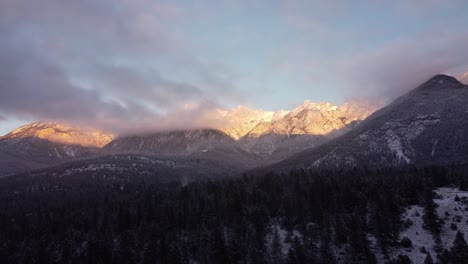 aerial shot of sunset in the rocky mountains in winter