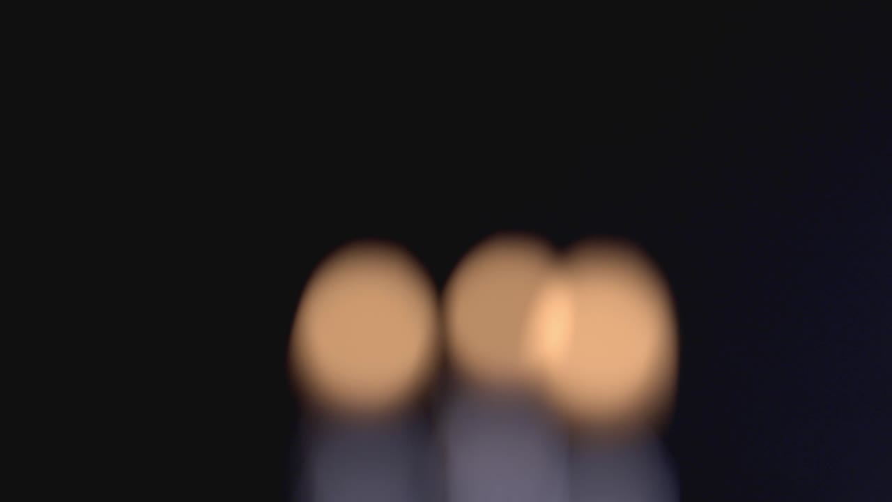 Beautiful Yellow Bokeh From Candle Lights On A Black Background. - close up shot