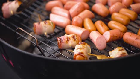 grilled bacon-wrapped sausages on a barbecue