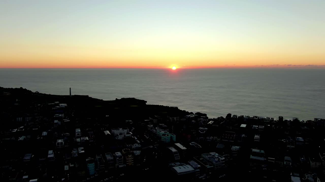 Sunrise on Bondi Beach, Sydney Australia.A Misty Golden Sunrise at Bondi Beach, Sydney Australia. aerial shot of sunrise with building and sea view.
