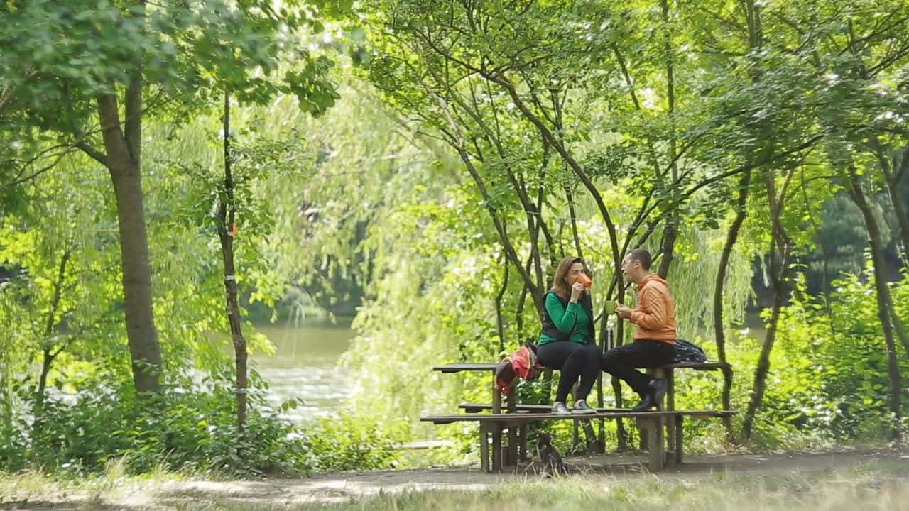 Loving Couple Drinking Tea. Romantic couple sitting in nature and drinking tea