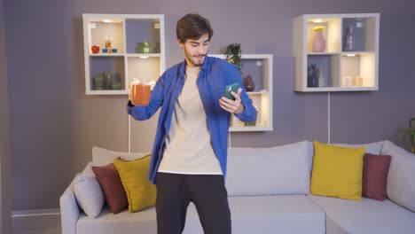 Young-man-is-happy-and-dancing-at-home-in-the-morning.