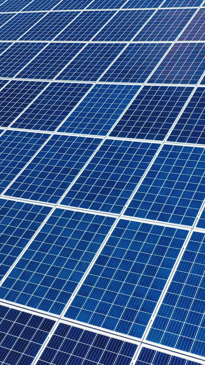 Aerial view. Top view on blue solar pannels. Green energy. Pannels on the roof. Vertical video