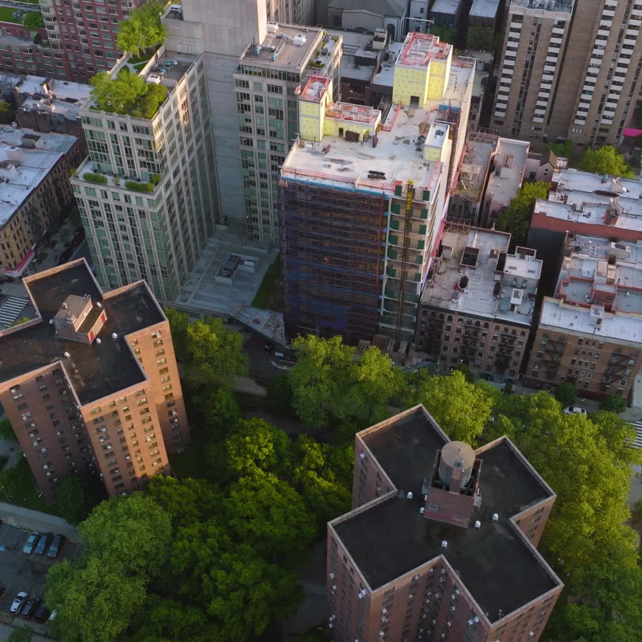 Flying over the residential area in New York city. Railways of subway along with roads and cars moving on. Aerial view