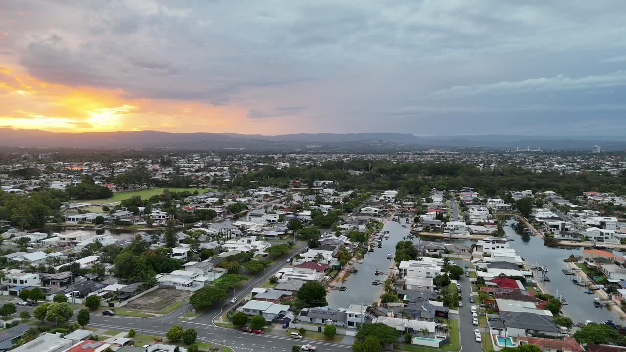 Timelapse of sunset over suburban houses and roads