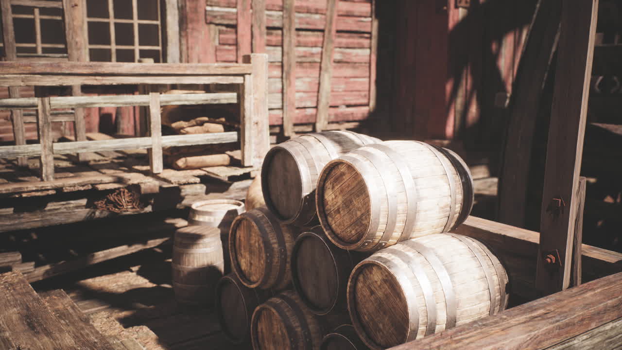 Wooden barrels stacked in a rustic warehouse during the afternoon light