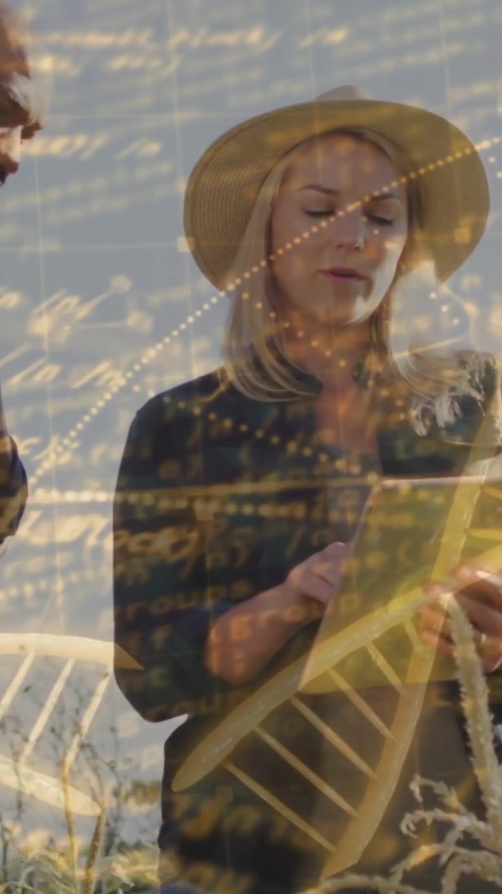 Vertical video: Woman tapping tablet, showing gold DNA overlay with man watching checking crop data