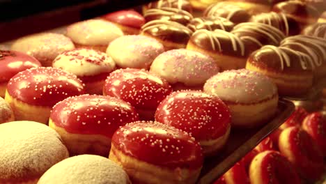 assortment of donuts in a bakery display case