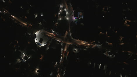 close top down aerial hyperlapse of busy intersection in bo, sierra leone at night.